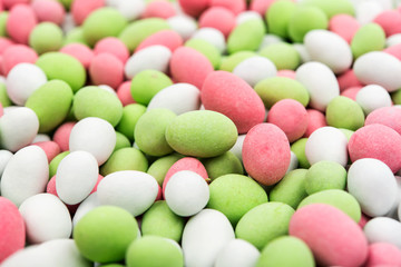 Colored dragées with walnut close-up