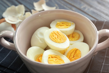 Bowl with tasty hard boiled eggs on table. Nutrition concept