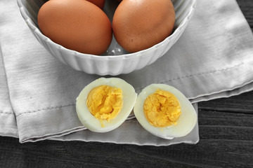 Hard boiled egg and bowl on napkin. Nutrition concept