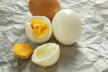Tasty hard boiled eggs on parchment paper. Nutrition concept