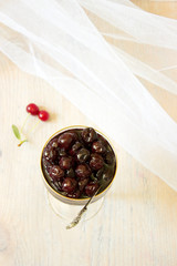 Glass with homemade Cherry Jam on wooden background
