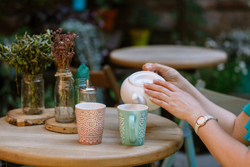 woman are drinking tea in street cafe