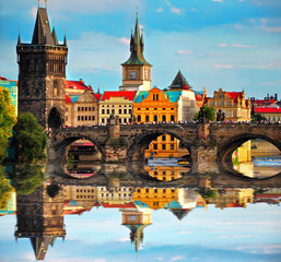  Charles bridge in Prague Czech Republic. Beautiful view of famous bridge, colorful architecture and Vltava river with reflection