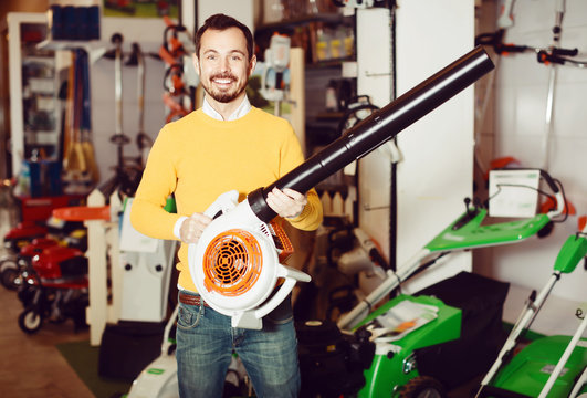 Young Man Choosing Leaf Blower