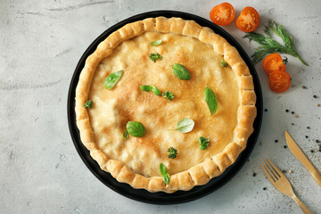 Baking dish with turkey pot pie on light background