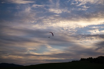 Paraglider flying in the air during colorful sunset. Slovakia