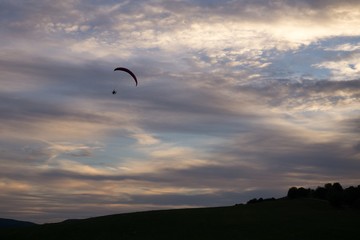 Paraglider flying in the air during colorful sunset. Slovakia