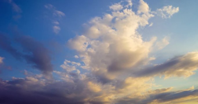 Time lapse clip of evening fluffy curly rolling clouds
