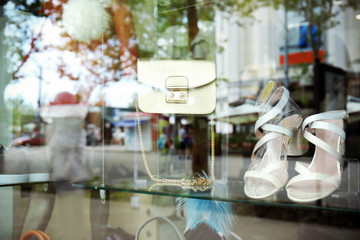 View through showcase on shoes and accessories in shop