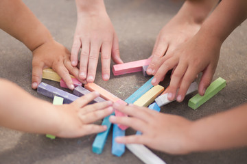 Fototapeta premium Kids hands and chalk, outdoors, closeup