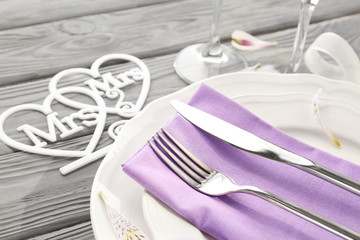 Beautiful table setting for lesbian wedding on wooden background