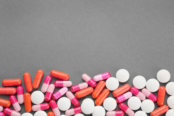 Health care concept. Colorful pills on grey background