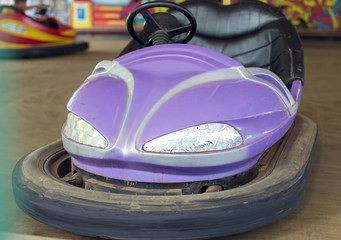 Fototapeta na wymiar Purple electric bumper car in amusement park.
