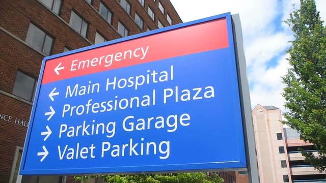 Establishing shot of sign at hospital that reads Main Hospital and Emergency.