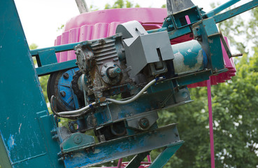 Old engine of ferris wheel in the city park.