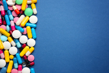 Different pills on color background