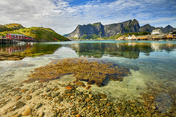 Scenic fjord on Lofoten islands with typical red fishing hut, Sakrisoy, Norway