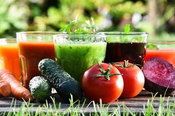 Glasses with fresh organic detox juices in the garden