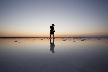 man standing sunset silhouette at salt lake