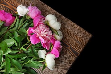 Beautiful bouquet with fragrant peonies on wooden table