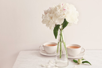 Fototapeta na wymiar Vase with beautiful peony flowers on table