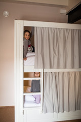two young girls about to go to sleep on bunk bed