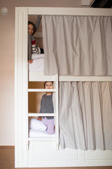 two young girls about to go to sleep on bunk bed