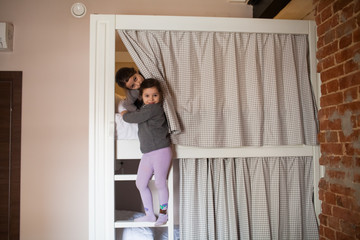 two young girls about to go to sleep on bunk bed