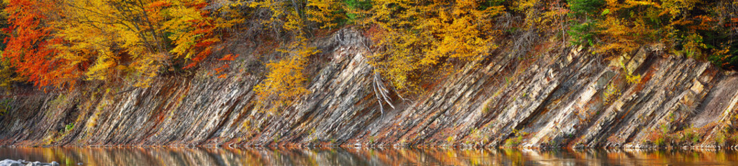 Rocky shore of lake in autumn time