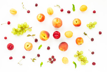 Colorful fruits assorted. Healthy fresh fruit background with garpes, plum, nectarine, peach, apricot, cherry, cherries, mint on white background. Flat lay, top view