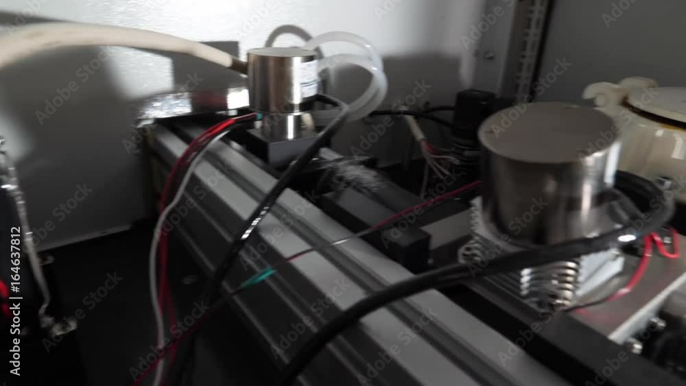 Poster close up of 3d printer operating in design studio. electronic three dimensional plastic printer duri