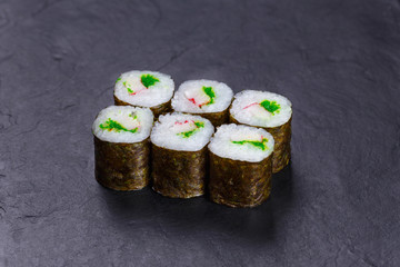 Delicious fresh multicolored sushi rolls with crab meat and caviar, restaurant menu