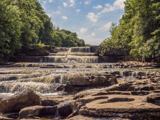 The Lower Falls, Aysgarth waterfalls on beautiful summers day at Aysgarth, Leyburn, North Yorkshire, UK