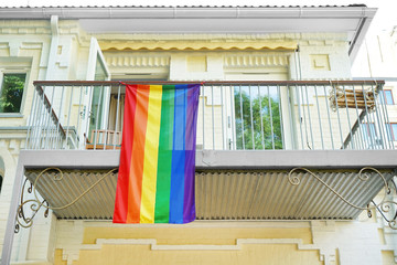 Gay flag on balcony outdoors