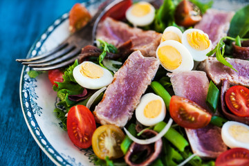 Tuna salad with tomatoes, boiled eggs, onion, anchovy and lettuce