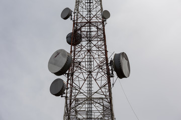 Telecommunication towers on cloudy sky