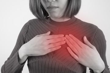 asian woman is clutching her chest. Heart disease. Acute pain possible heart attack. Healthcare, Medical and sickness concept