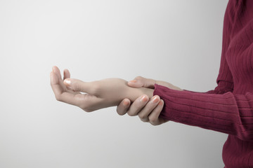 Young woman holding her wrist pain