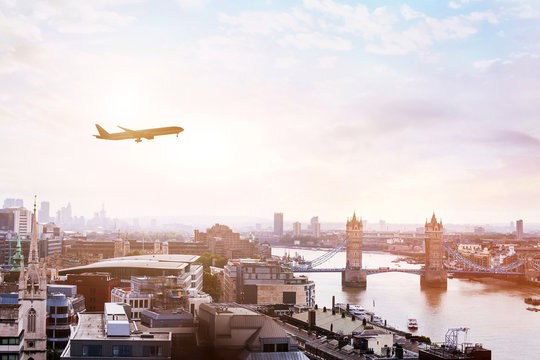 Fototapeta travel to London by flight, airplane in the sky over Tower Bridge