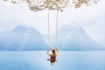 dream concept, beautiful young woman on the swing in fjord Norway, inspiring landscape - obrazy, fototapety, plakaty