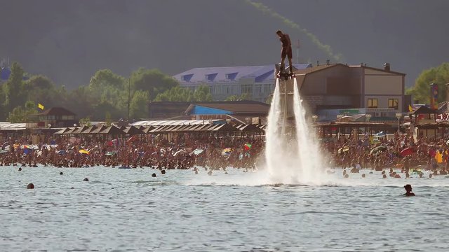 Flyboard.The silhouette of man at sea flyboard. Sunset on sea holidays