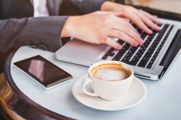 working on computer online, woman checking email on laptop in cafe, social network or internet concept