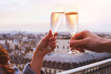 two glasses of champagne or wine, couple dating concept, romantic celebration of engagement or...