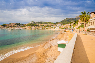 Puerto de Soller, Port of Mallorca island in balearic islands, Spain. Beautiful  beach and bay with boats in clear blue water of summer day.