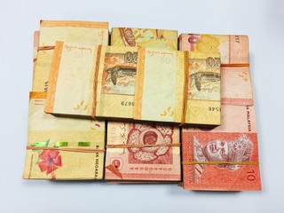 Malaysia Currency (MYR): Stack of Ringgit Malaysia bank note with isolated white background. There are ten and twenty ringgit Malaysia.
