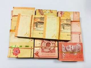 Malaysia Currency (MYR): Stack of Ringgit Malaysia bank note with isolated white background. There are ten and twenty ringgit Malaysia.