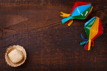 Wooden background with wicker hat for brazilian festivel Festa Junina