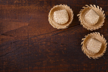 Wooden background with wicker hat for brazilian festivel Festa Junina