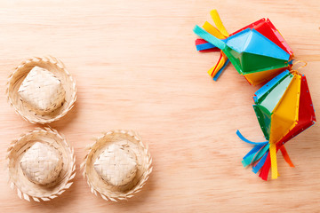 Wooden background with wicker hat for brazilian festivel Festa Junina