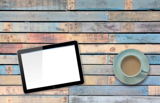 Computer Tablet with Hand Pointing or Swiping on Blue painted Table by Coffee or Tea cup
